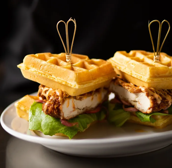 Copper House signature dishes Chicken and Waffle SandwichSteak and GritsSalmon BLTSalted Caramel Brown Sugar Cake